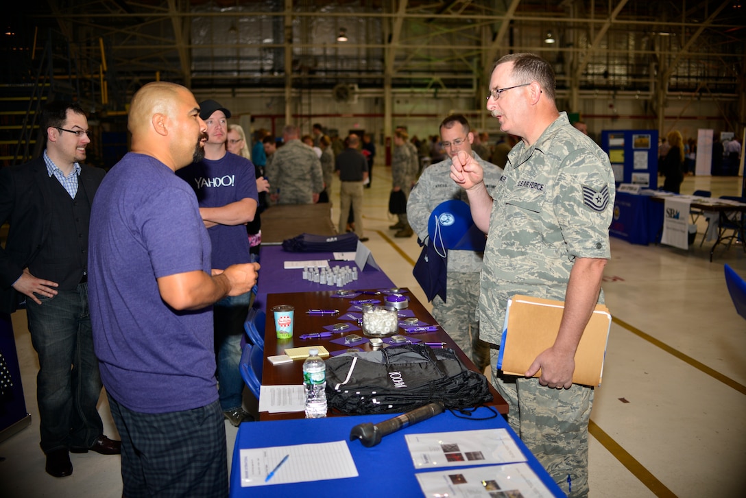 Tech Sgt. Edward Chandler, Wing SharePoint administrator, 914th Communications Squadron speaks to a career fair representative at the Niagara Falls Air Reserve Station on June 4, 2015. More than 100 employers from all sectors of business were available for the two-day event. (U.S. Air Force photo by Tech. Sgt. Stephanie Sawyer)