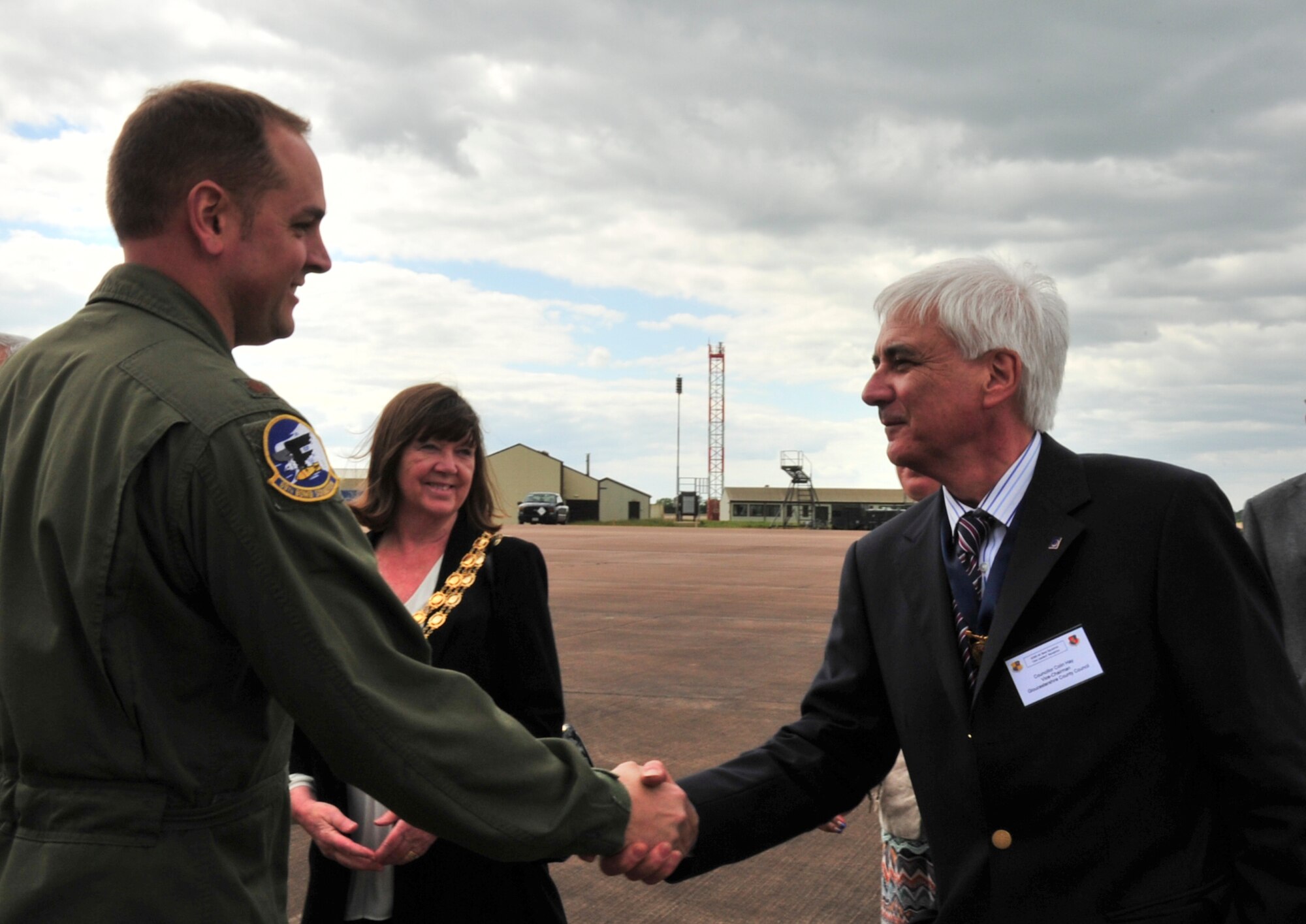 Maj. Luke Dellenbach, 69th Bomb Squadron director of staff, greets a local civic leader during a tour of the B-52H Stratofortress at Royal Air Force Fairford, England, June 9, 2015. While at RAF Fairford, the bombers will conduct training flights with ground and naval forces around the region and participate in multi-national exercises BALTOPS 15 and Saber Strike 15. Bomber operations provide credible, flexible and ready capability to respond to a variety of potential threats and situations. (U.S. Air Force photo/Senior Airman Malia Jenkins)  