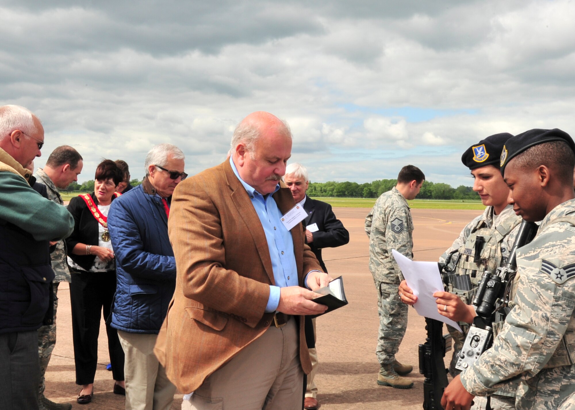 Security forces members from Minot Air Force Base, N.D., check the identification of local civic leaders before a tour of a B-52H Stratofortress at Royal Air Force Fairford, England, June 9, 2015. Local civic leaders came to the base to learn about the B-52 and its capabilities as well as how the pilots operate the 50 year-old aircraft. The bombers will conduct training flights with ground and naval forces around the region and participate in multi-national exercises BALTOPS 15 and Saber Strike 15. Combined training and theater security cooperation engagements with the United States’ allies and partners demonstrate all organizations share a commitment to promoting a peaceful and stable Europe. (U.S. Air Force photo/Senior Airman Malia Jenkins)    