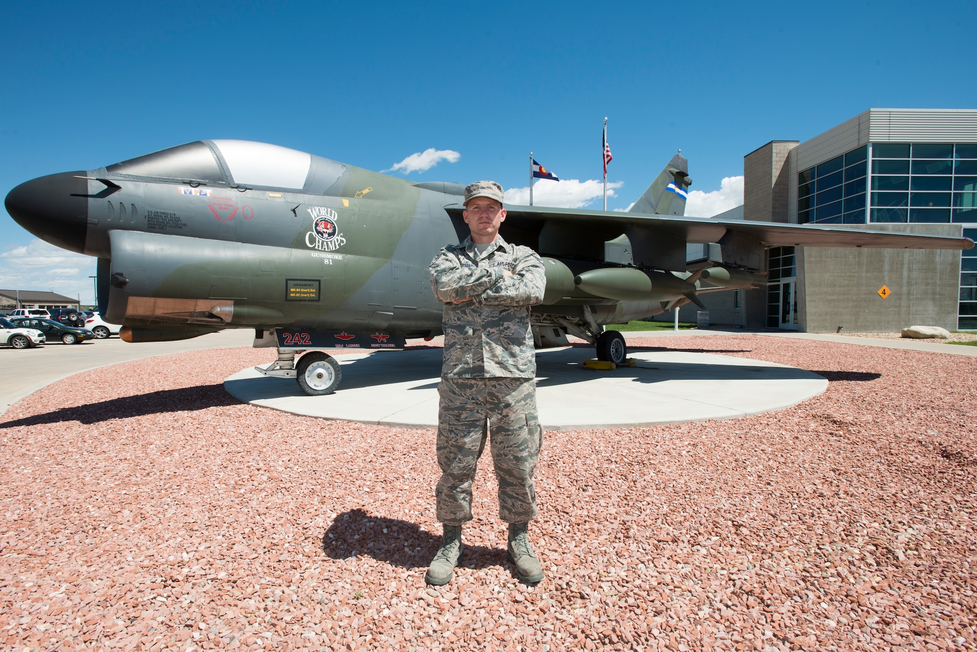 U.S. Air Force Senior Airman Jonathan R. Smail, a transmission technician from the 233rd Space Communications Squadron, Colorado Air National Guard, poses in front of a static display in front of the headquarters building at the Greeley Air National Guard Station, Greeley, Colo., June 7, 2015. Smail, who troubleshoots and maintains satellite communications electronic equipment for the 233rd's one-of-a-kind mobile nuclear and missile launch tracking mission, won the 2014 Air National Guardsman of the year. (Air National Guard photo by Tech. Sgt. Wolfram M. Stumpf)