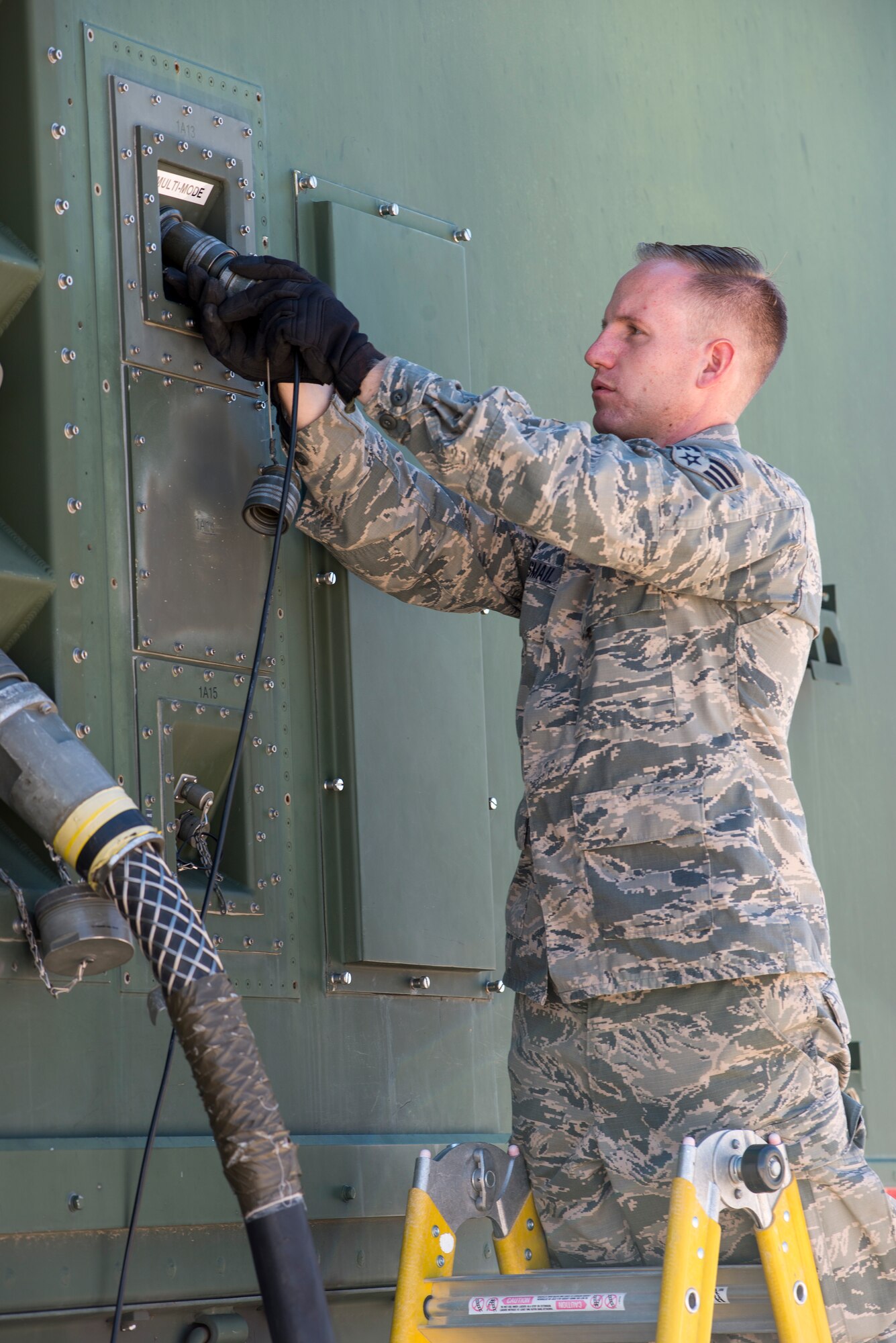 U.S. Air Force Senior Airman Jonathan R. Smail, a transmission technician from the 233rd Space Communications Squadron, Colorado Air National Guard, checks the cables hooked up to a mobile satellite trailer at Greeley Air National Guard Station, Greeley, Colo., June 7, 2015. Smail, who troubleshoots and maintains satellite communications electronic equipment for the 233rd's one-of-a-kind mobile nuclear and missile launch tracking mission, won the 2014 Air National Guardsman of the year. (Air National Guard photo by Tech. Sgt. Wolfram M. Stumpf)