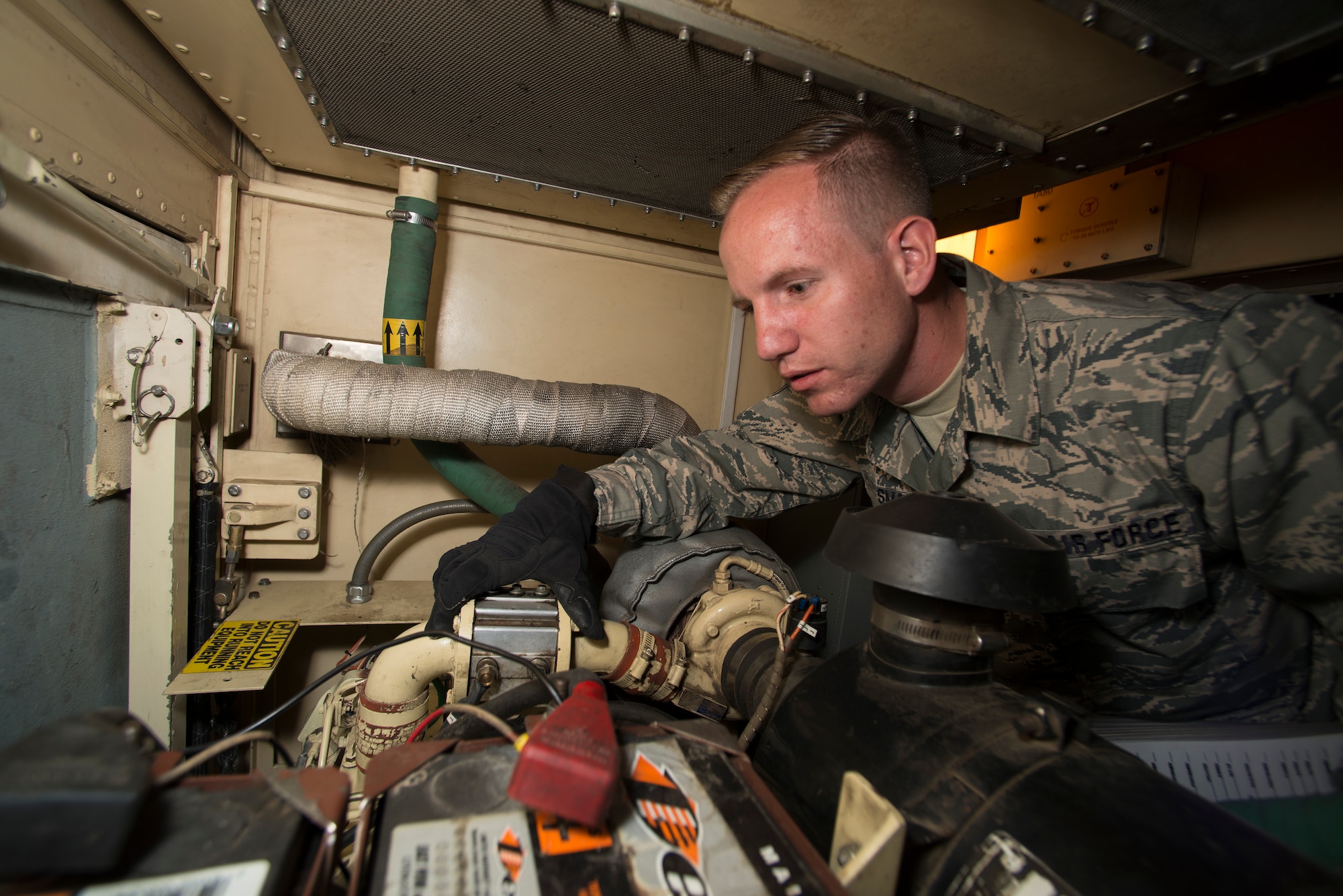 U.S. Air Force Senior Airman Jonathan R. Smail, a transmission technician from the 233rd Space Communications Squadron, Colorado Air National Guard, inspects the generators in a mobile satellite trailer at Greeley Air National Guard Station, Greeley, Colo., June 7, 2015. Smail, who troubleshoots and maintains satellite communications electronic equipment for the 233d's one-of-a-kind mobile nuclear and missile launch tracking mission, won the 2014 Air National Guardsman of the year. (Air National Guard photo by Tech. Sgt. Wolfram M. Stumpf)