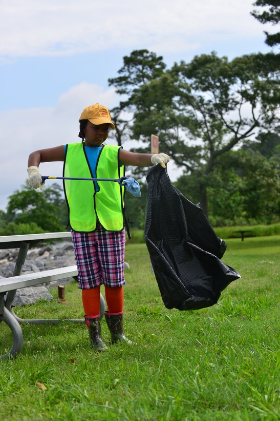 Jourdan Griffin, daughter of U.S. Army Capt. Wayne Griffin, Bravo Company, 1st Battalion, 210th Aviation Regiment commander, participates in Clean the Bay Day at Fort Eustis, Va., June 6, 2015. This was the 27th annual Clean the Bay Day, a Virginia wide conservation effort. (U.S. Air Force photo by Staff Sgt. Natasha Stannard/Released)