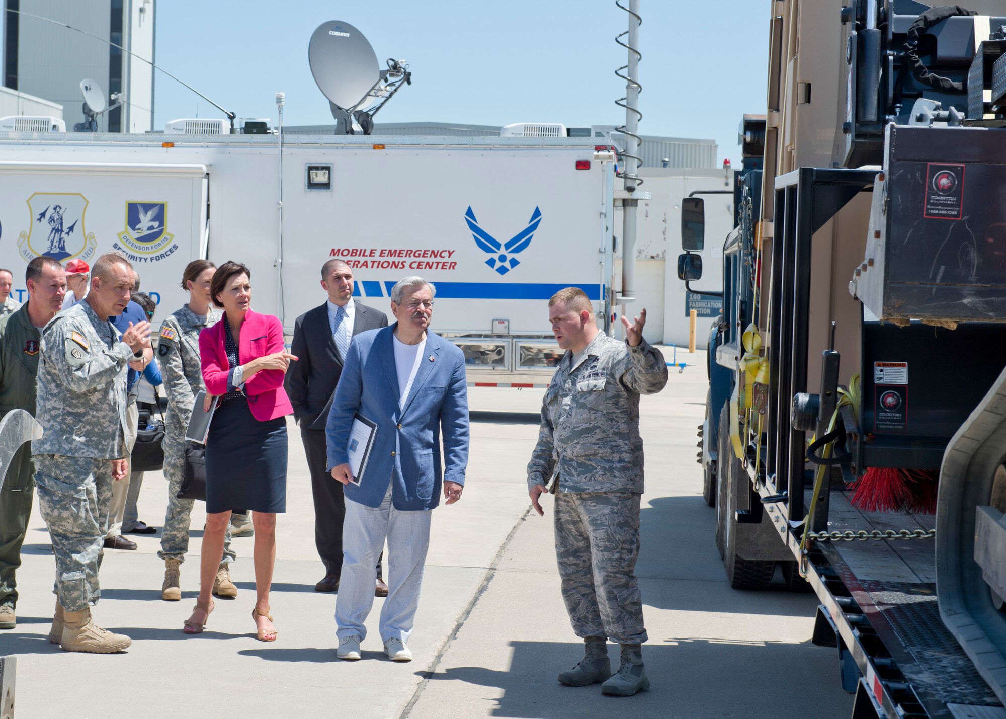 The 132nd Wing, Iowa Air National Guard based in Des Moines, Iowa hosted Iowa Governor Terry Branstad and Lieutenant Governor Kim Reynolds during a tour of the Wing’s capabilities on June 9. Maj. Gen. Timothy Orr, The Adjutant General of Iowa (far left), also attended, as Iowa officials were briefed on the unit’s three new missions – Intelligence Surveillance Reconnaissance, Defensive Cyber Operations, and MQ-9 Remotely Piloted Aircraft flying operations.  Iowa Air National Guard Master Sgt. Cameron Stufflebeam demonstrates the unit’s civil engineering capabilities. (Iowa Air National Guard photo by Senior Airman Michael J. Kelly)