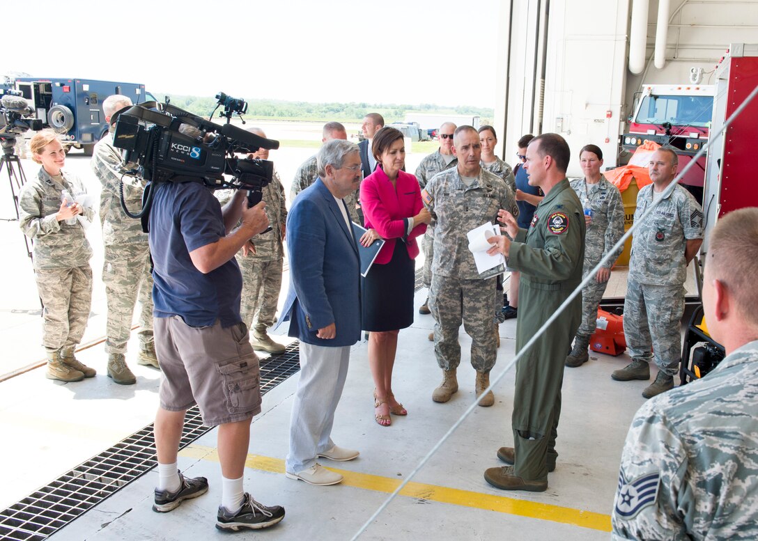 The 132nd Wing, Iowa Air National Guard based in Des Moines, Iowa hosted Iowa Governor Terry Branstad and Lieutenant Governor Kim Reynolds during a tour of the Wing’s capabilities on June 9. Maj. Gen. Timothy Orr, The Adjutant General of Iowa (center), also attended, as Iowa officials were briefed on the unit’s three new missions – Intelligence Surveillance Reconnaissance, Defensive Cyber Operations, and MQ-9 Remotely Piloted Aircraft flying operations. Col. Kevin Heer (in flight suit), commander of the 132nd Wing, briefs the group on the 132nd’s Fire Department capabilities.  (Iowa Air National Guard photo by Tech. Sgt. Linda K. Burger)