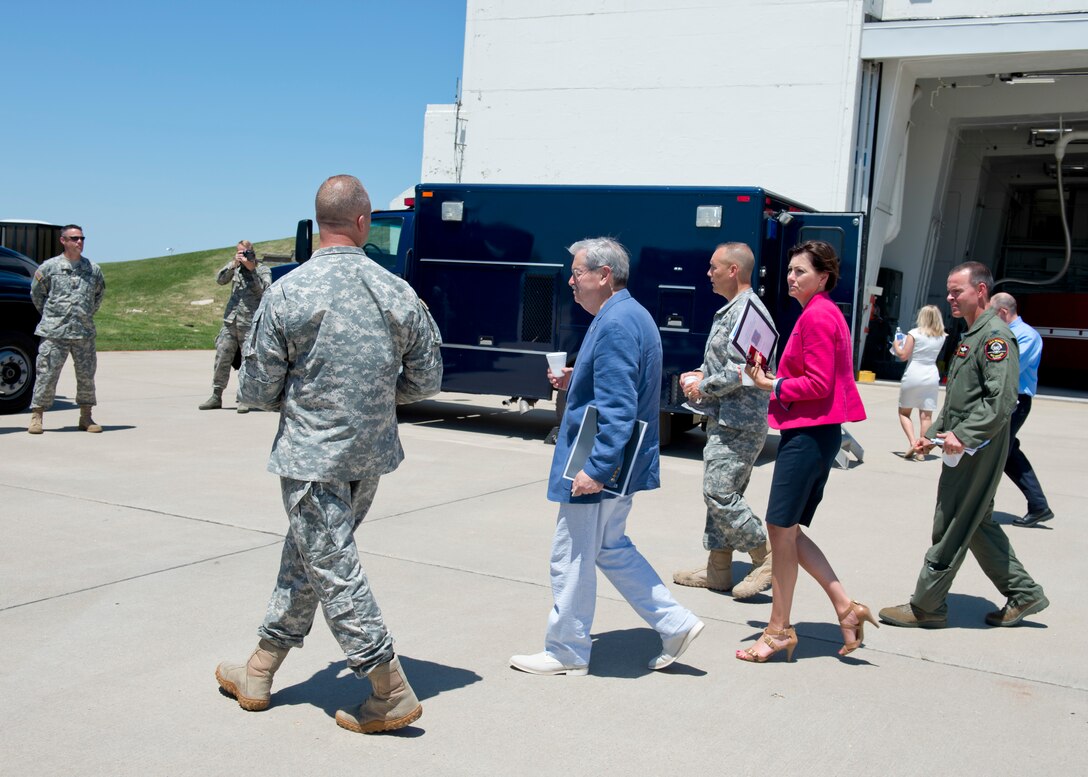 The 132nd Wing, Iowa Air National Guard based in Des Moines, Iowa hosted Iowa Governor Terry Branstad and Lieutenant Governor Kim Reynolds during a tour of the Wing’s capabilities on June 9. Maj. Gen. Timothy Orr, The Adjutant General of Iowa (center), also attended, as Iowa officials were briefed on the unit’s three new missions – Intelligence Surveillance Reconnaissance, Defensive Cyber Operations, and MQ-9 Remotely Piloted Aircraft flying operations. Lt. Col. Russell Bossard (to the left of Branstad) visits with the group.  (Iowa Air National Guard photo by Tech. Sgt. Linda K. Burger)