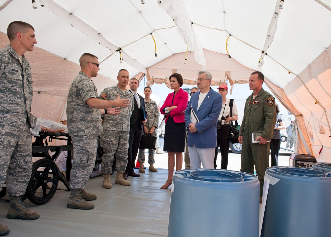 The 132nd Wing, Iowa Air National Guard based in Des Moines, Iowa hosted Iowa Governor Terry Branstad and Lieutenant Governor Kim Reynolds during a tour of the Wing’s capabilities on June 9. Maj. Gen. Timothy Orr, The Adjutant General of Iowa (center left), and 132nd Wing Commander Col. Kevin Heer (far right) also attended, as Iowa officials were briefed on the unit’s three new missions – Intelligence Surveillance Reconnaissance, Defensive Cyber Operations, and MQ-9 Remotely Piloted Aircraft flying operations. Capt. Brandon Cochran (second from left) explains the capabilities of the Wing’s Medical counter-Chemical Biological Radiological Nuclear and Explosive (CBRNE) program. (Iowa Air National Guard photo by Tech. Sgt. Linda K. Burger)