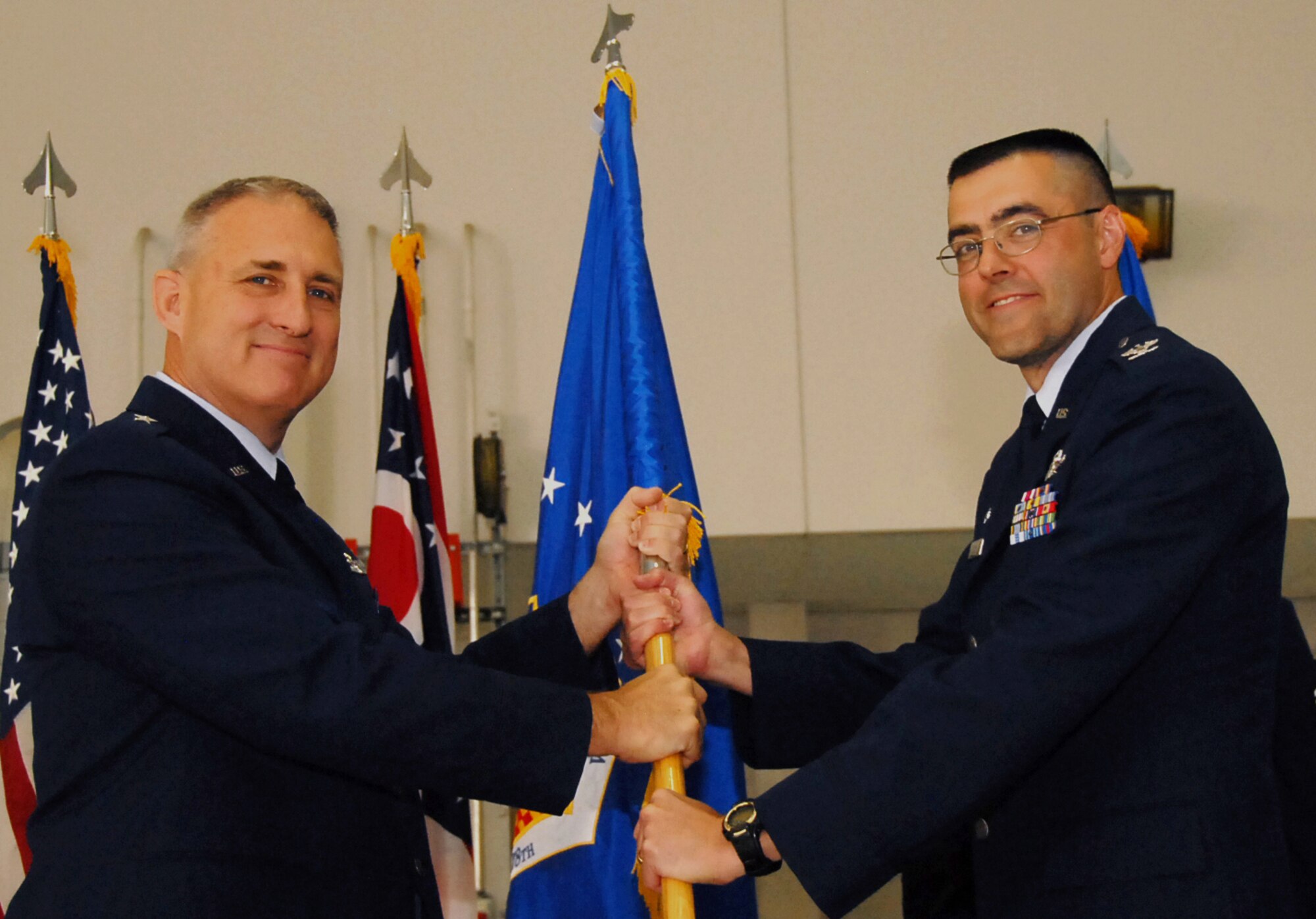 Commander of the Ohio Air National Guard, Brig. Gen. Stephen Markovich gives Col. Bryan Davis the 178th Wing guidon representing Davis' assumption of command of the 178th Wing, June 6, at the Springfield Air National Guard Base. Davis replaced Col. Gregory Schnulo who will move on to become the assistant adjutant general for the Ohio Air National Guard. (Ohio Air National Guard photo by Airman Rachel Simones/Released)