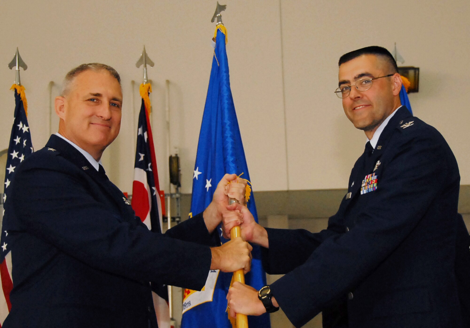 Commander of the Ohio Air National Guard, Brig. Gen. Stephen Markovich gives Col. Bryan Davis the 178th Wing guidon representing Davis' assumption of command of the 178th Wing, June 6, at the Springfield Air National Guard Base. Davis replaced Col. Gregory Schnulo who will move on to become the assistant adjutant general for the Ohio Air National Guard. (Ohio Air National Guard photo by Airman Rachel Simones/Released)