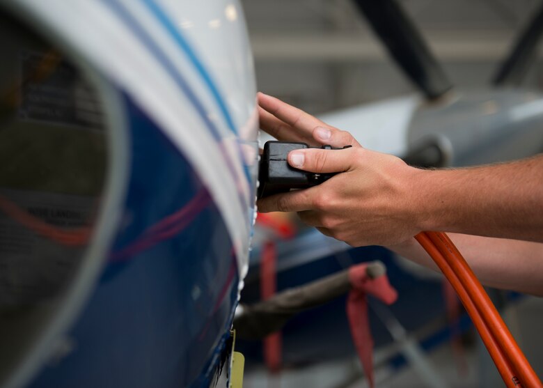 Senior Airman Kristopher Golden, 919th Special Operations Aircraft Maintenance Group, plugs the external power into the C-145 June 6 at Duke Field, Fla. The 919th SOMXG is comprised of 919th SOMXS, 919th SOAMXS, 919th SOMOF, and the 592nd SOMXS.  Their primary mission is the maintenance of the C-145 aircraft.  (U.S. Air Force photo/Tech. Sgt. Jasmin Taylor)