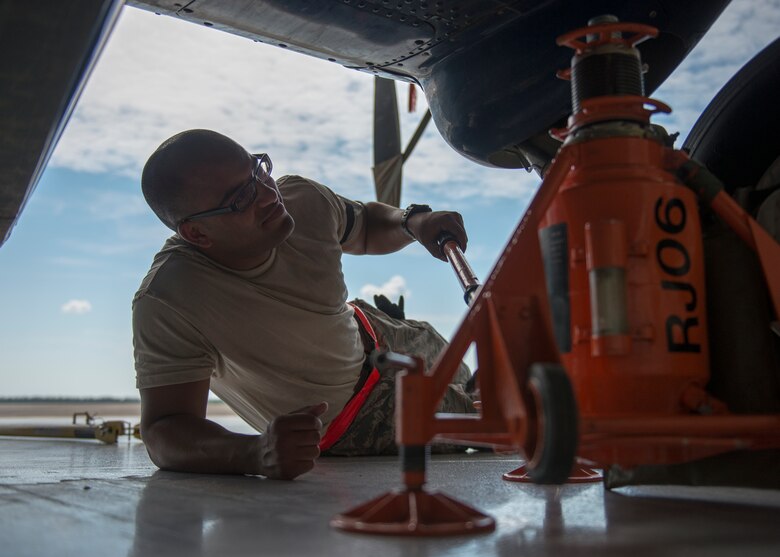Senior Airman Kevin Cahn, 919th Special Operations Aircraft Maintenance Group, uses the jack to lift the landing gear June 6 at Duke Field, Fla. The 919th SOMXG is comprised of 919th SOMXS, 919th SOAMXS, 919th SOMOF, and the 592nd SOMXS.  Their primary mission is the maintenance of the C-145 aircraft.  (U.S. Air Force photo/Tech. Sgt. Jasmin Taylor)