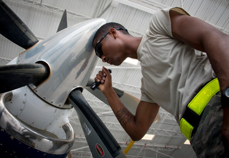 Airman Mario Hill, 919th Special Operations Maintenance Group, shines a flashlight into the intake to perform routine maintenance on a C-145 June 6 at Duke Field, Fla. The 919th SOMXG is comprised of 919th SOMXS, 919th SOAMXS, 919th SOMOF, and the 592nd SOMXS.  Their primary mission is the maintenance of the C-145 aircraft.  (U.S. Air Force photo/Tech. Sgt. Jasmin Taylor)