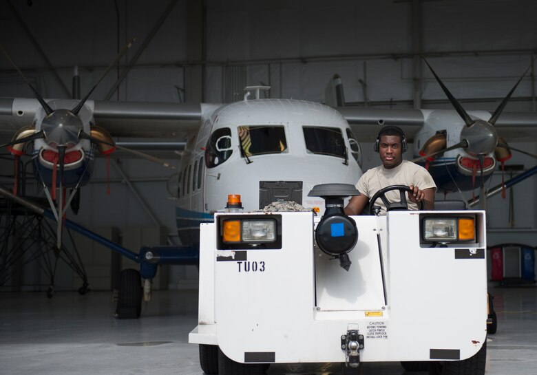Senior Airman Brandon Elliott, 919th Special Operations Maintenance Group, begins to tow the C-145 June 6 at Duke Field, Fla. The 919th SOMXG is comprised of 919th SOMXS, 919th SOAMXS, 919th SOMOF, and the 592nd SOMXS.  Their primary mission is the maintenance of the C-145 aircraft.  (U.S. Air Force photo/Tech. Sgt. Jasmin Taylor)