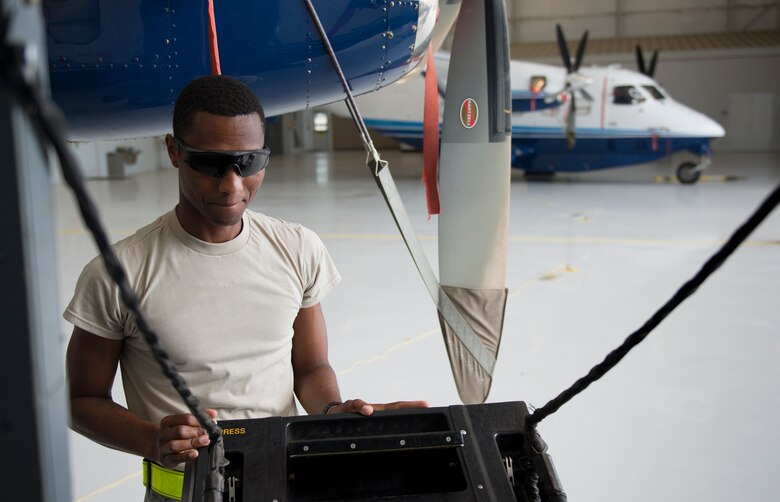 Airman Mario Hill, 919th Special Operations Maintenance Group, closes the door of a C-145 June 6 at Duke Field, Fla. The 919th SOMXG is comprised of 919th SOMXS, 919th SOAMXS, 919th SOMOF, and the 592nd SOMXS.  Their primary mission is the maintenance of the C-145 aircraft.  (U.S. Air Force photo/Tech. Sgt. Jasmin Taylor)