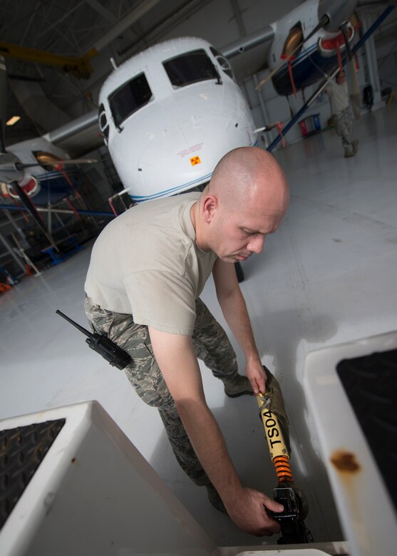 Staff Sgt. Jeremy Hosbein, 919th Special Operations Maintenance Group, disconnects the bar connecting the aircraft to the towing vehicle June 6 at Duke Field, Fla. The 919th SOMXG is comprised of 919th SOMXS, 919th SOAMXS, 919th SOMOF, and the 592nd SOMXS.  Their primary mission is the maintenance of the C-145 aircraft. (U.S. Air Force photo/Tech. Sgt. Jasmin Taylor)