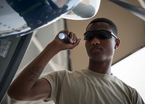 Airman Mario Hill, 919th Special Operations Maintenance Group, shines a flashlight into the intake to perform routine maintenance on a C-145 June 6 at Duke Field, Fla. The 919th SOMXG is comprised of 919th SOMXS, 919th SOAMXS, 919th SOMOF, and the 592nd SOMXS.  Their primary mission is the maintenance of the C-145 aircraft.  (U.S. Air Force photo/Tech. Sgt. Jasmin Taylor)