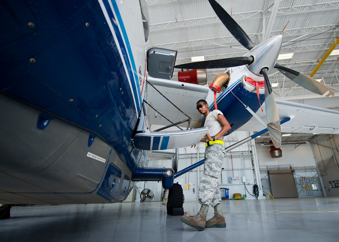 Airman Mario Hill, 919th Special Operations Maintenance Group, opens up the door of a C-145 June 6 at Duke Field, Fla. The 919th SOMXG is comprised of 919th SOMXS, 919th SOAMXS, 919th SOMOF, and the 592nd SOAMXS.  Their primary mission is the maintenance of the C-145 aircraft. (U.S. Air Force photo/Tech. Sgt. Sam King)