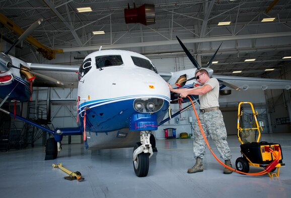 Senior Airman Kristopher Golden, 919th Special Operations Maintenance Group, removes the external power from the C-145 June 6 at Duke Field, Fla. The 919th Special Operations Maintenance Group is comprised of 919th SOMXS, 919th SOAMXS, 919th SOMOF, and the 592nd SOMXS.  Their primary mission is the maintenance of the C-145 aircraft. (U.S. Air Force photo/Tech. Sgt. Sam King)
