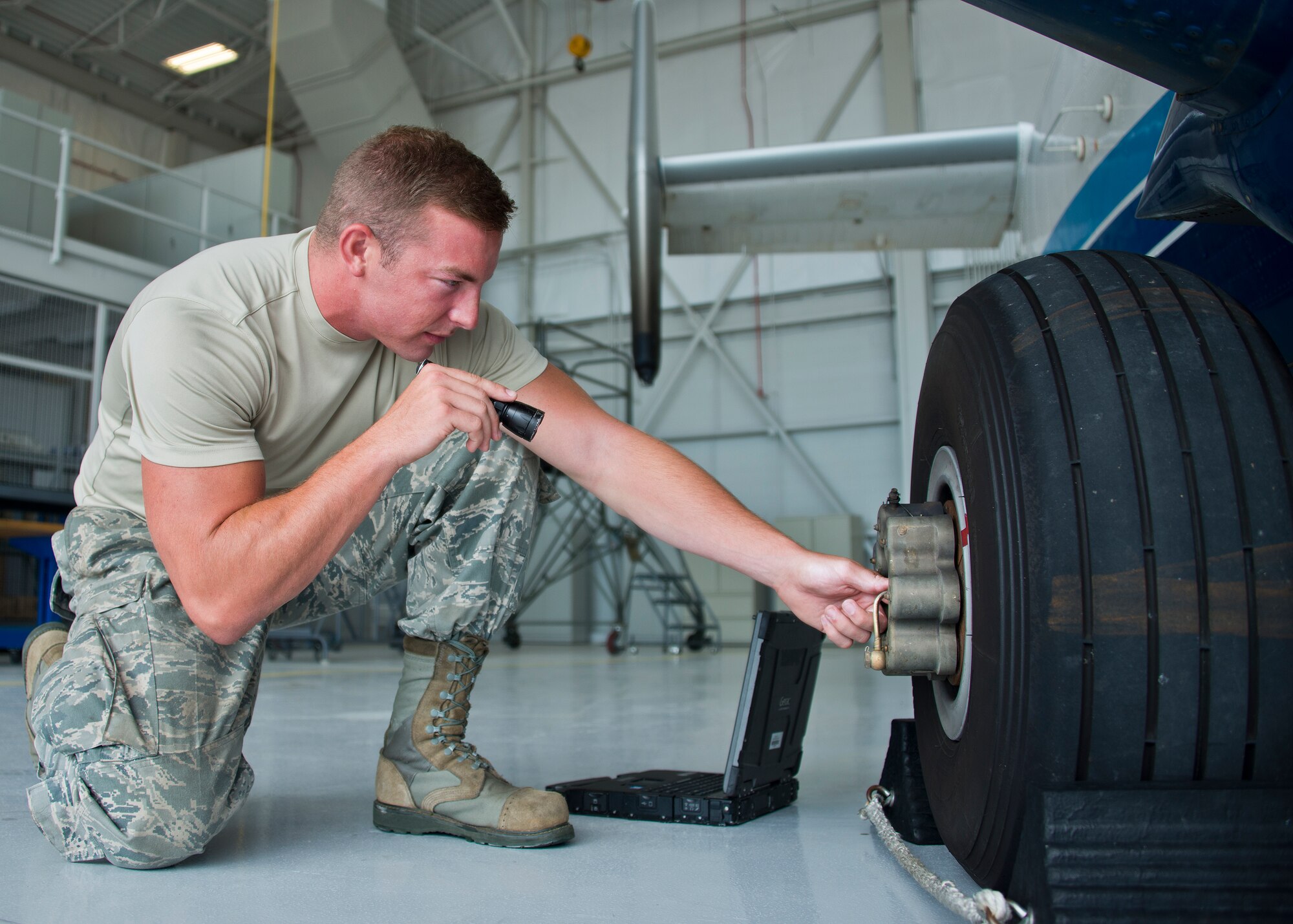 Senior Airman Kristopher Golden, 919th Special Operations Maintenance Group, checks the brakes of a C-145 June 6 at Duke Field, Fla. The 919th SOMXG is comprised of 919th SOMXS, 919th SOAMXS, 919th SOMOF, and the 592nd SOMXS.  Their primary mission is the maintenance of the C-145 aircraft. (U.S. Air Force photo/Tech. Sgt. Sam King)