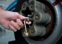 Senior Airman Kristopher Golden, 919th Special Operations Maintenance Group, checks the brakes of a C-145 June 6 at Duke Field, Fla. The 919th SOMXG is comprised of 919th SOMXS, 919th SOAMXS, 919th SOMOF, and the 592nd SOMXS.  Their primary mission is the maintenance of the C-145 aircraft. (U.S. Air Force photo/Tech. Sgt. Sam King)