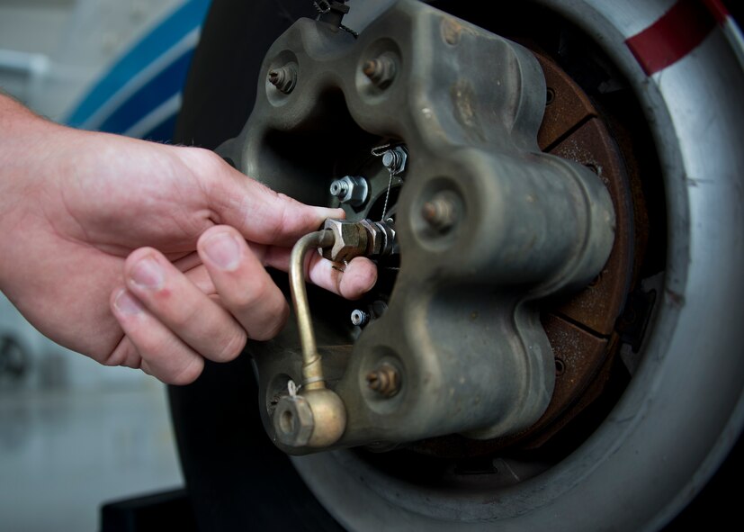 Senior Airman Kristopher Golden, 919th Special Operations Maintenance Group, checks the brakes of a C-145 June 6 at Duke Field, Fla. The 919th SOMXG is comprised of 919th SOMXS, 919th SOAMXS, 919th SOMOF, and the 592nd SOMXS.  Their primary mission is the maintenance of the C-145 aircraft. (U.S. Air Force photo/Tech. Sgt. Sam King)
