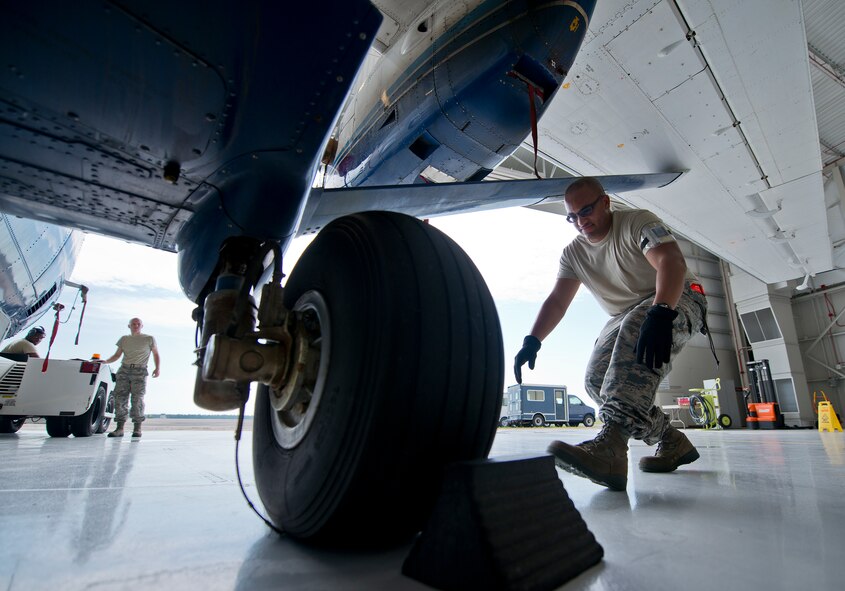 Senior Airman Kevin Kahn, 919th Special Operations Maintenance Group, moves in to remove the chocks from a C-145 June 6 at Duke Field, Fla. The 919th SOMXG is comprised of 919th SOMXS, 919th SOAMXS, 919th SOMOF, and the 592nd SOAMXS.  Their primary mission is the maintenance of the C-145 aircraft. (U.S. Air Force photo/Tech. Sgt. Sam King)