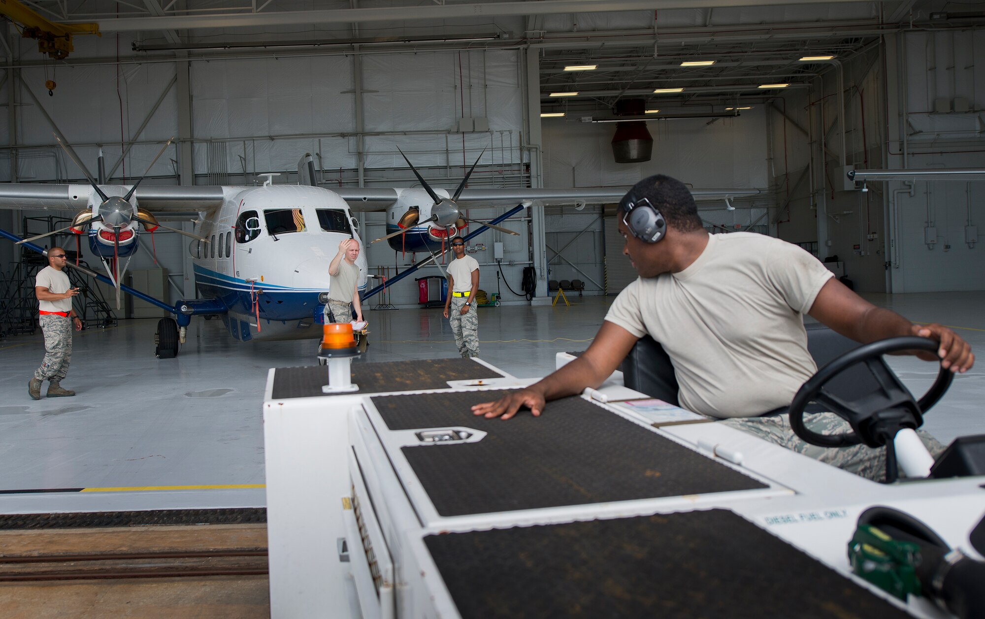 Senior Airman Brandon Elliott, 919th Special Operations Maintenance Group, backs up the tow vehicle toward a C-145 June 6 at Duke Field, Fla. The 919th SOMXG is comprised of 919th SOMXS, 919th SOAMXS, 919th SOMOF, and the 592nd SOMXS.  Their primary mission is the maintenance of the C-145 aircraft.  (U.S. Air Force photo/Tech. Sgt. Sam King)