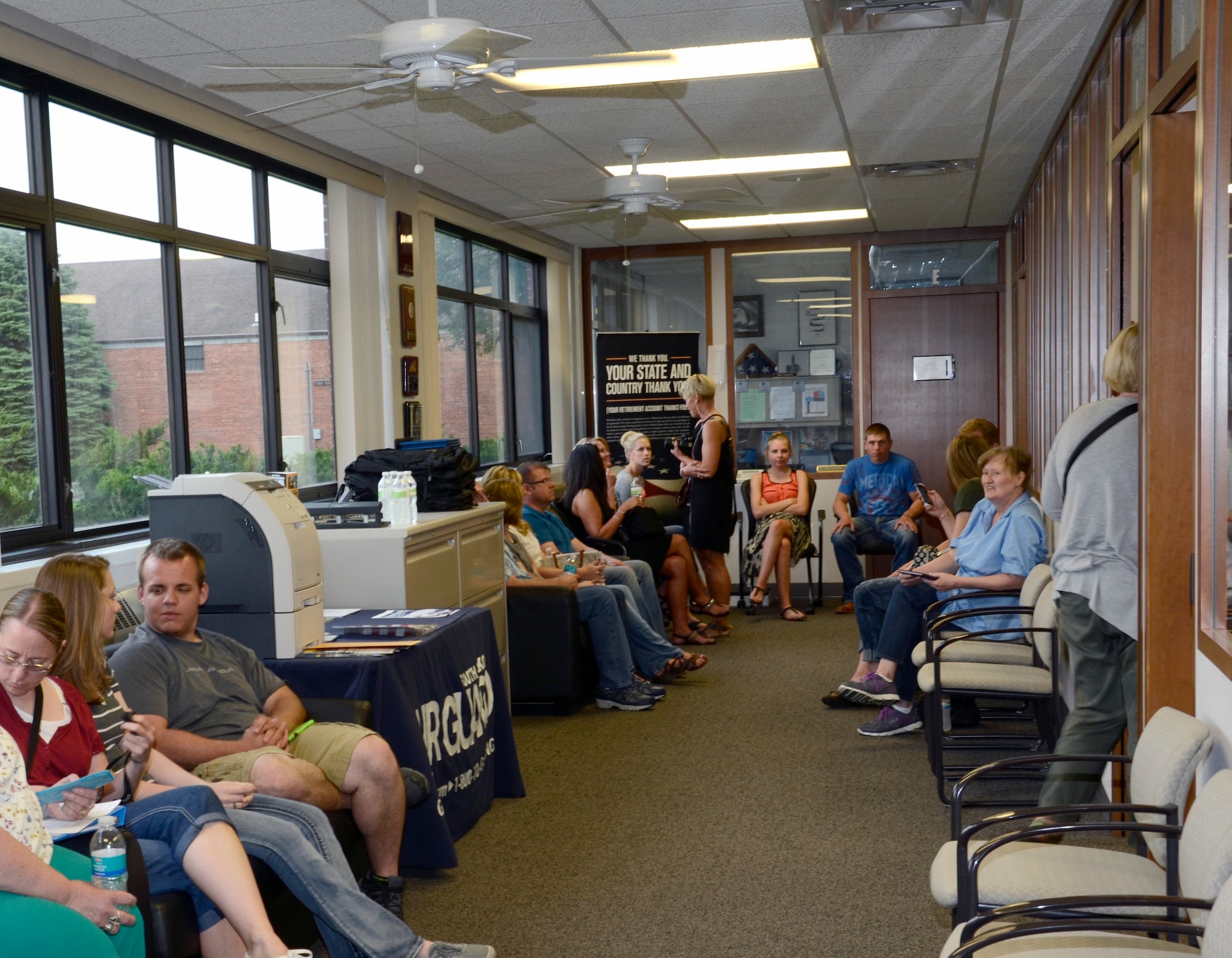 SIOUX FALLS, S.D. - New enlistees and their families wait patiently in the recruiting office for their turn to sign their enlistment contracts to join the South Dakota Air National Guard at Joe Foss Field, S.D. June 5, 2015.  114th Force Support Squadron personnel worked overtime to ensure these new members were enlisted before the deadline for them to recieve their enlistment bonus for joining the unit.(National Guard photo by Senior Master Sgt. Nancy Ausland/Released)