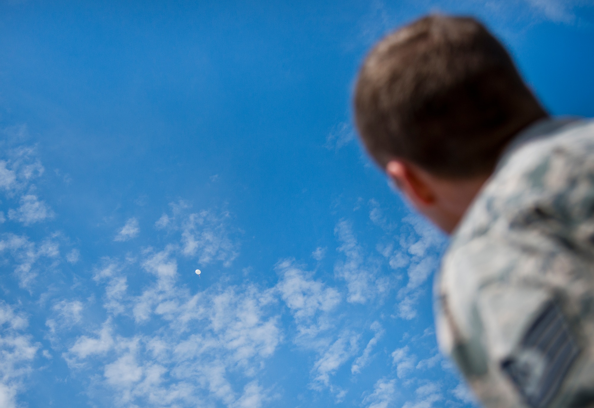 Tech. Sgt. Nathan Halvorson, 96th Weather Flight, watches a just-released weather balloon rises into the sky above Eglin Air Force Base, Fla.  (U.S. Air Force photo/Samuel King Jr.)