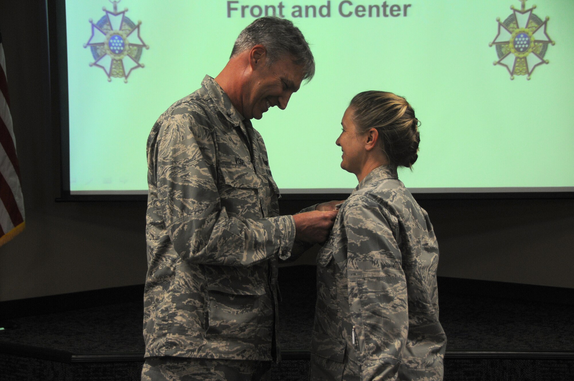Brig. Gen. Kurt Vogel, Arkansas Air National Guard commander, presents Col. Bobbi Doorenbos, 188th Wing commander, with the Legion of Merit June 7, 2015 at Ebbing Air National Guard Base, Fort Smith, Ark. The award is to recognize Doorenbos for her achievements as the 214th Reconnaissance Group commander for the 162nd Wing in Arizona. (U.S. Air National Guard photo by Senior Airman Cody Martin/Released)