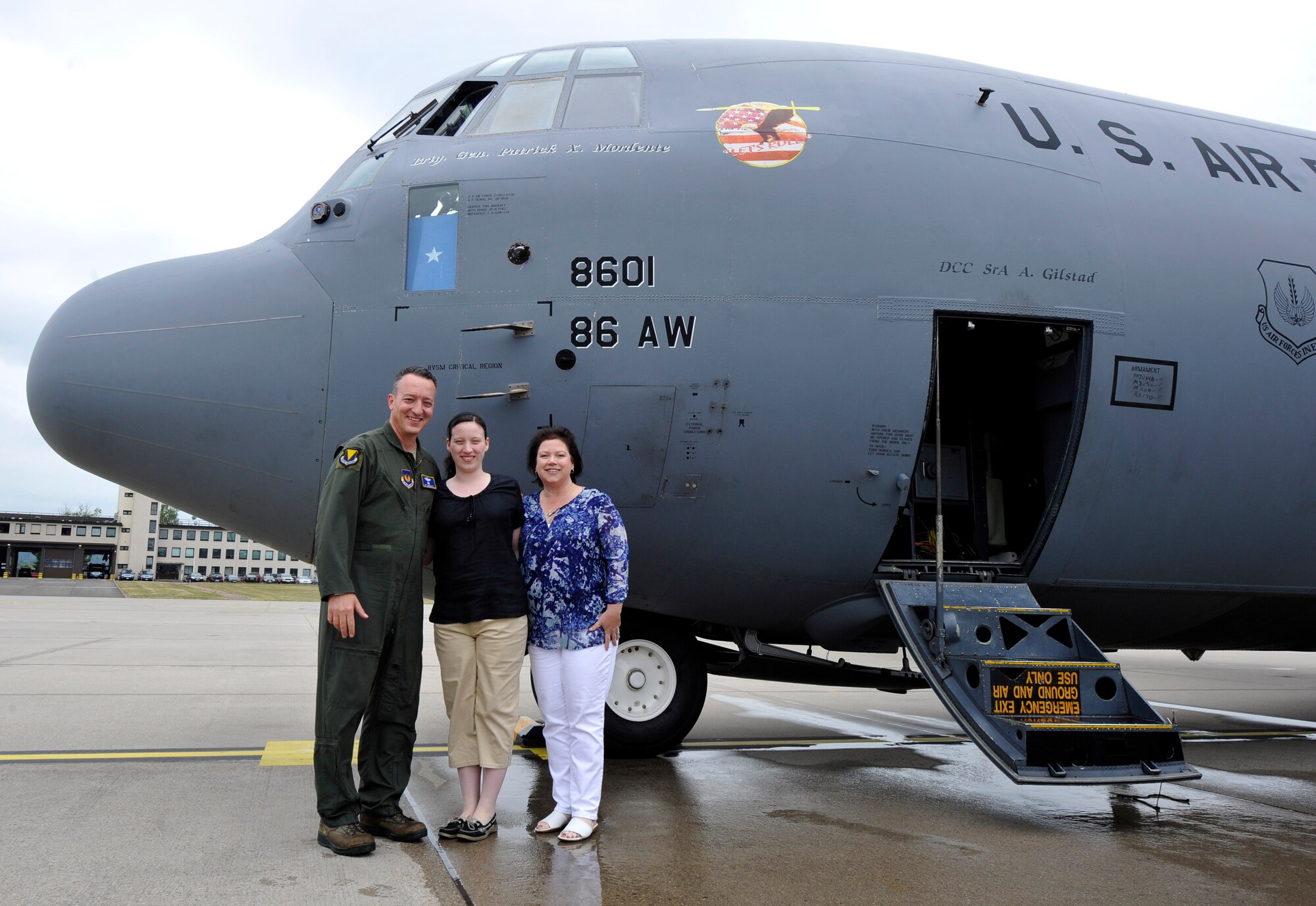 Brig. Gen. Patrick X. Mordente, 86th Airlift Wing commander, takes a photo with his daughter, Catherine, and wife, Marissa, after his final flight on June 10, 1015, at Ramstein Air Base, Germany. Marissa marshalled Mordente’s C-130J Super Hercules in where he was greeted by friends, family and Airmen. Mordente has led six groups and 27 squadrons as the wing commander since June 2013. (U.S. Air Force photo/1st Lt. Clay Lancaster) 