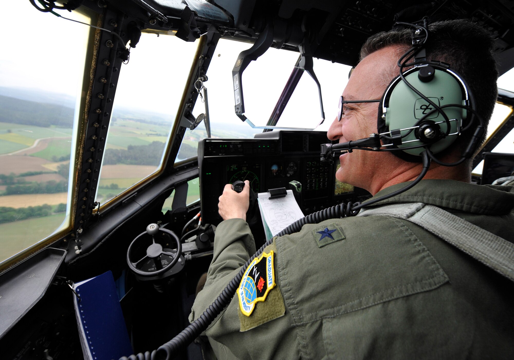 Brig. Gen. Patrick X. Mordente, 86th Airlift Wing commander, overlooks a river region near Ramstein Air Base, Germany, during his final flight aboard a C-130J Super Hercules June 10, 2015. Mordente, after completing his command tour here at Ramstein,  has been selected to serve as the 18th Air Force vice commander at Scott Air Force Base, Illinois. (U.S. Air Force photo/Staff Sgt. Leslie Keopka)