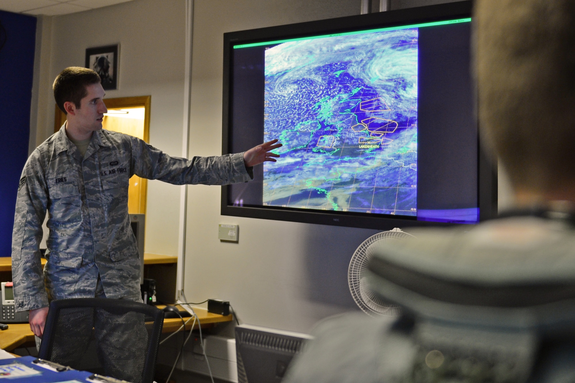 Senior Airman Christopher Fries, 48th Operations Support Squadron weather forecaster, briefs the most up-to-date weather intelligence to pilots before they fly their training mission for the day at Royal Air Force Lakenheath, England, May 28, 2015. Fries was nominated for a Liberty Spotlight because he embodies the core values of Integrity First, Service Before Self and Excellence In All We Do. (U.S. Air Force photo by Airman 1st Class Erin R. Babis/Released)