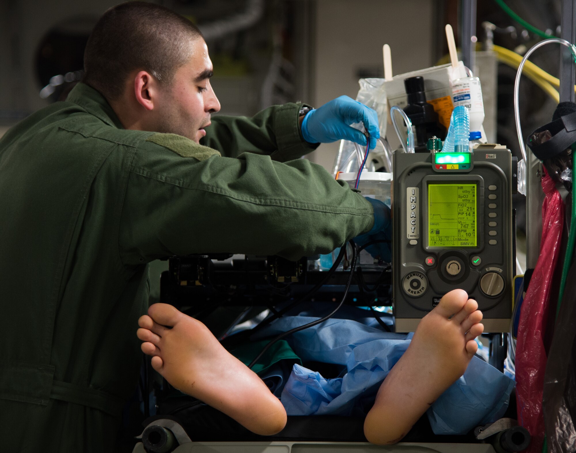 An Airman with the 86th Medical Squadron prepares a patient for flight June 8, 2015, Bulgaria. Airmen from Strategic Airlift Capability Heavy Airlift Wing from Pápa Air Base, Hungary and Ramstein Air Base, Germany, joined together to transport patients to Landstuhl Regional Medical Center, Germany for additional support while providing in-flight care. This was the first time both bases joined together for a critical care aeromedical transport. The multinational aircrew that comprised the mission and operated the airlift capability are from Pápa AB, Hungary and provide combat and humanitarian airlift and AE support in responding to mission requests throughout different areas of responsibility. (U.S. Air Force photo/Senior Airman Jonathan Stefanko)