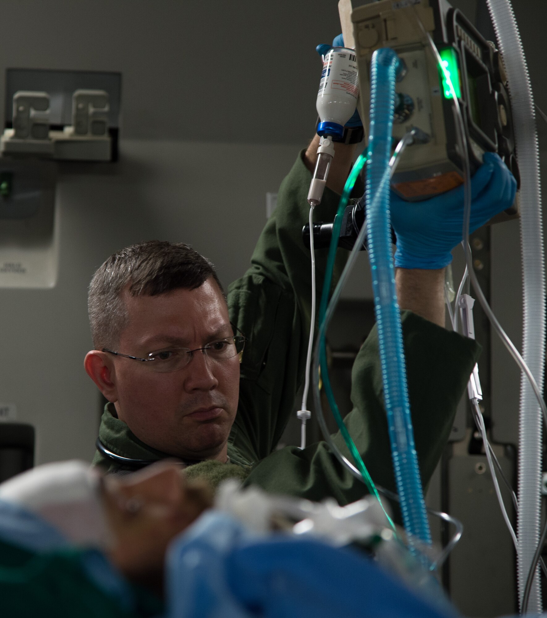 Maj. Scott Jensen, 86th Medical Squadron critical care air transport team physician, sets up equipment for a wounded patient June 8, 2015, Bulgaria. Airmen from Ramstein Air Base, Germany, worked alongside the Strategic Airlift Capability Heavy Airlift Wing from Pápa AB, Hungary, to provide aeromedical evacuation transport and care. This was the first time both bases joined together for a critical care aeromedical transport. (U.S. Air Force photo/Senior Airman Jonathan Stefanko)