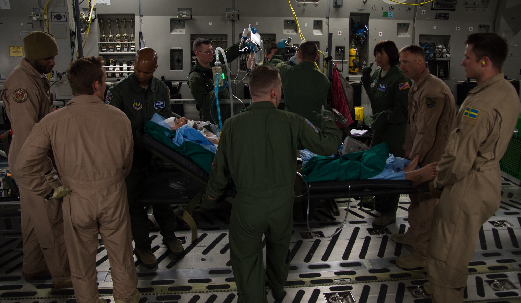 Airmen from Strategic Airlift Capability Heavy Airlift Wing based at Pápa  Air Base, Hungary and Ramstein Air Base, Germany, carry a wounded patient onto a C-17 Globemaster III for transport June 8, 2015, Bulgaria. The patient sustained injuries during a training event and was being sent to Landstuhl Regional Medical Center, Germany for medical care. The aeromedical evacuation capability at Ramstein AB was able to join forces with the Strategic Airlift Capability Heavy Airlift Wing to respond to provide care for the patient. The HAW is comprised of multinational aircrew members from 12 different nations and demonstrates a fully operational airlift capability in responding to airlift and AE missions. (U.S. Air Force photo/Senior Airman Jonathan Stefanko)