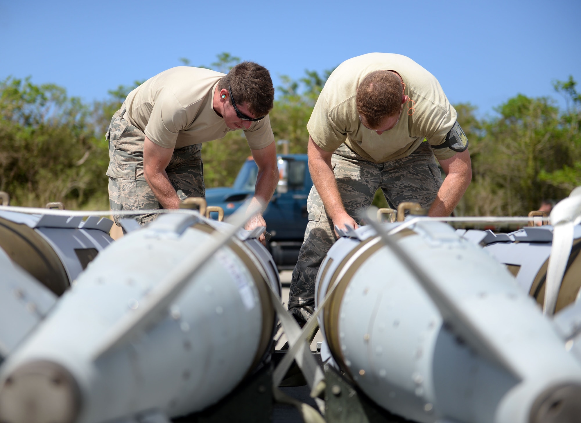 Staff Sgt. Nicholas Eder, 36th Munitions Squadron line delivery driver, and Tech. Sgt. Tyler Harrill, 7th Munitions Squadron munitions storage supervisor, tie down guided bomb units prior to delivering them to a weapons in-check station, June 1, 2015, Andersen Air Force Base, Guam. The 2015 Combat Ammunition Production Exercise included more than 250 Airmen from nine bases across the Pacific and U.S. (U.S. Air Force photo by Airman 1st Class Joshua Smoot/Released)