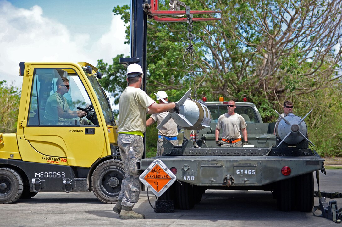 Conventional maintenance crew members load guided bomb units onto an MHU-110 trailer during the 2015 Combat Ammunition Production Exercise, Andersen Air Force Base, Guam June 1, 2015. CAPEX 2015 tested the 36th Munitions Squadron's and other deployed munitions units’ ability to build munitions and support combat sorties. (U.S. Air Force photo by Airman 1st Class Joshua Smoot/Released)