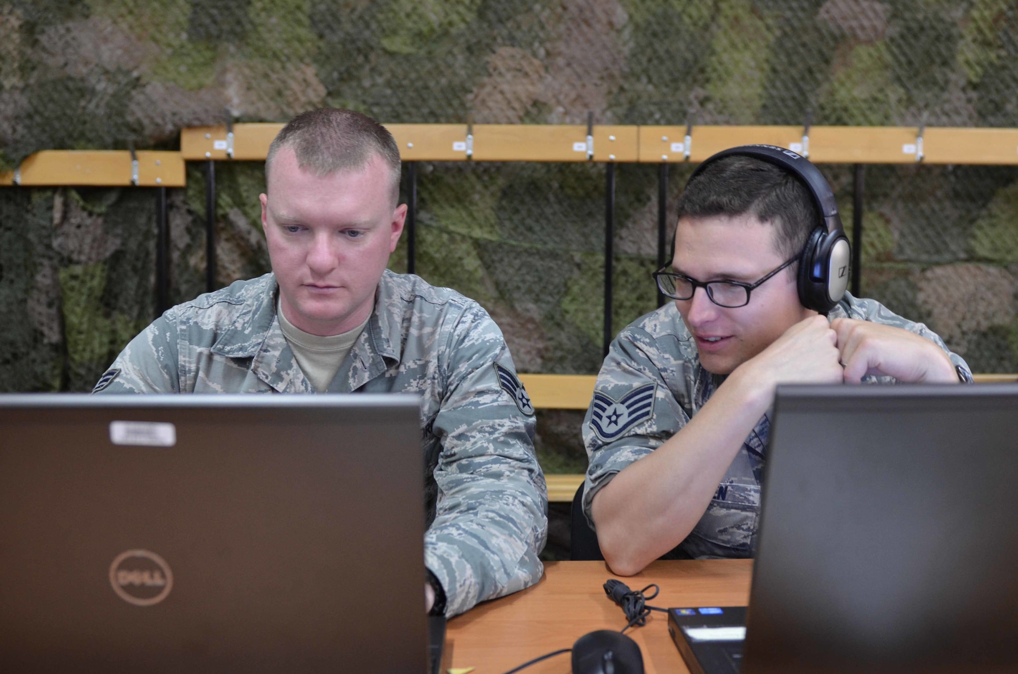 Senior Airman Steven Adkins, a broadcast journalist assigned to American Forces Network, Spangdahlem Air Base, Germany, and Staff Sgt. Ben Wocken, a broadcast journalist assigned to American Forces Network Europe Regional Media Center, review a video they are producing for Saber Strike 15 on June 7, 2015, in the Drawsko Pomorskie Training Area in Poland. Saber Strike is a long-standing U.S. Army Europe-led cooperative training exercise. This year’s exercise objectives facilitate cooperation amongst the U.S., Estonia, Latvia, Lithuania, and Poland to improve joint operational capability in a range of missions as well as preparing the participating nations and units to support multinational contingency operations. (U.S. Army photo by Sgt. Brandon Anderson, 13th Public Affairs Detachment/Released.)
