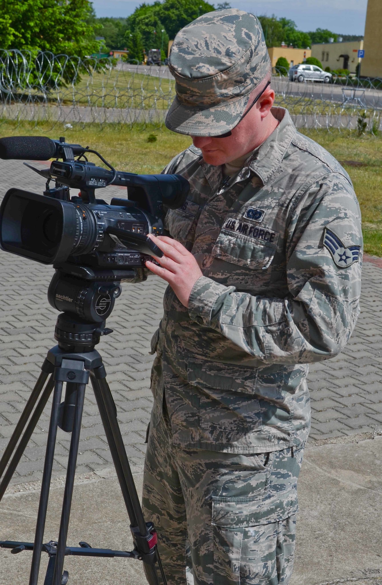 Senior Airman Steven Adkins, a broadcast journalist assigned to American Forces Network, Spangdahlem Air Base, Germany, focuses his video camera during an assignment for Saber Strike 15 on June 7, 2015, in the Drawsko Pomorskie Training Area in Poland. Saber Strike is a long-standing U.S. Army Europe-led cooperative training exercise. This year’s exercise objectives facilitate cooperation amongst the U.S., Estonia, Latvia, Lithuania, and Poland to improve joint operational capability in a range of missions as well as preparing the participating nations and units to support multinational contingency operations. (U.S. Army photo by Sgt. Brandon Anderson, 13th Public Affairs Detachment/Released.)