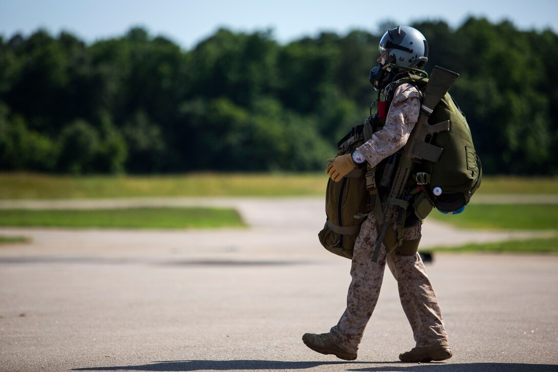A Marine prepares to board a CH-53 Super Stallion helicopter with all his gear for a high-altitude, high-opening jump during sustainment training in Louisburg, N.C., June 7, 2015.