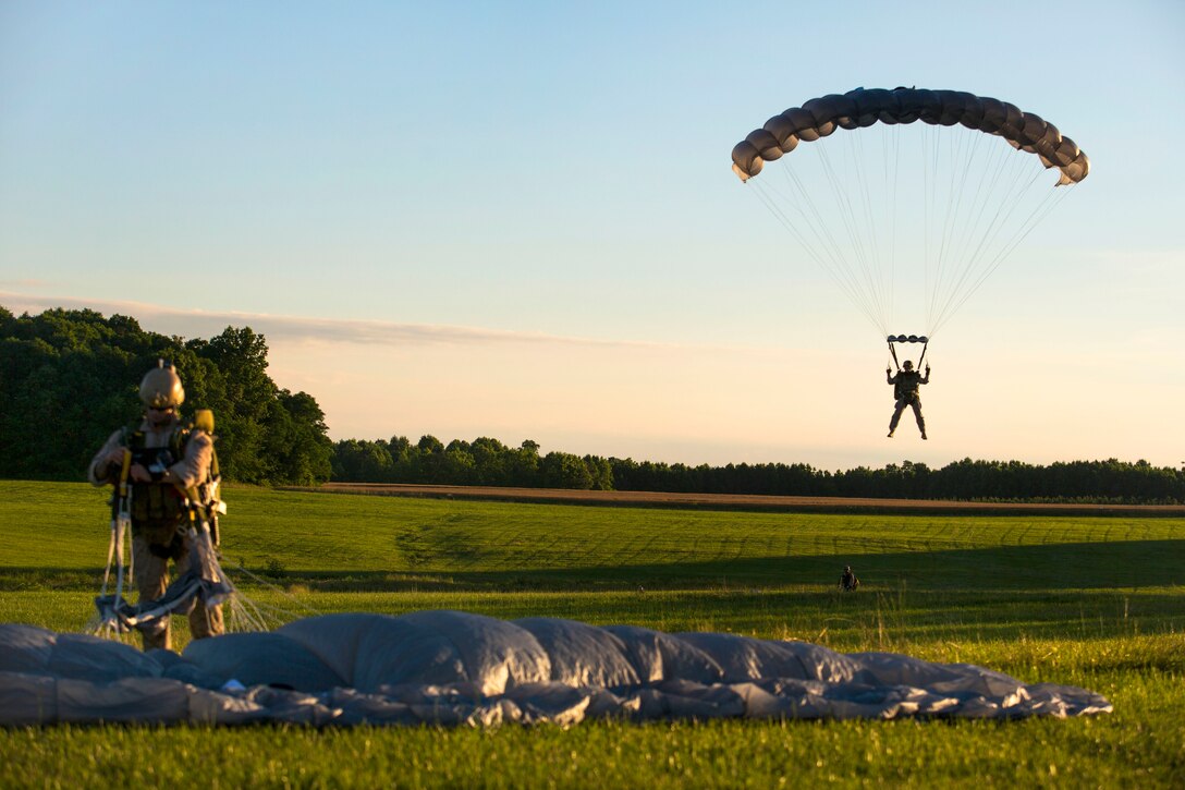 A Marine prepares to land on the drop zone after conducting a high-altitude, high-opening jump from a CH-53 Super Stallion helicopter during sustainment training in Louisburg, N.C., June 5, 2015. 