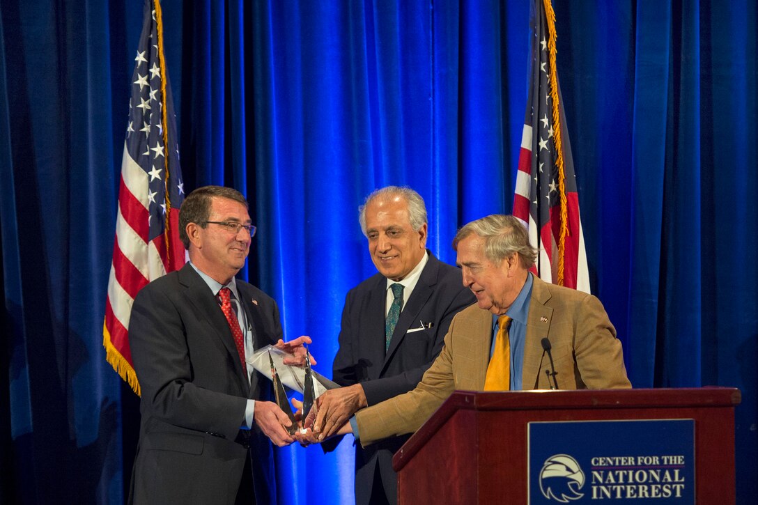Defense Secretary Ash Carter accepts the Center for the National Interest’s 2015 Distinguished Service Award from Zalmay Khalilzad, a member of the center’s board of directors, and Graham Allison, a member of its advisory council, in Washington, D.C., June 9, 2015.