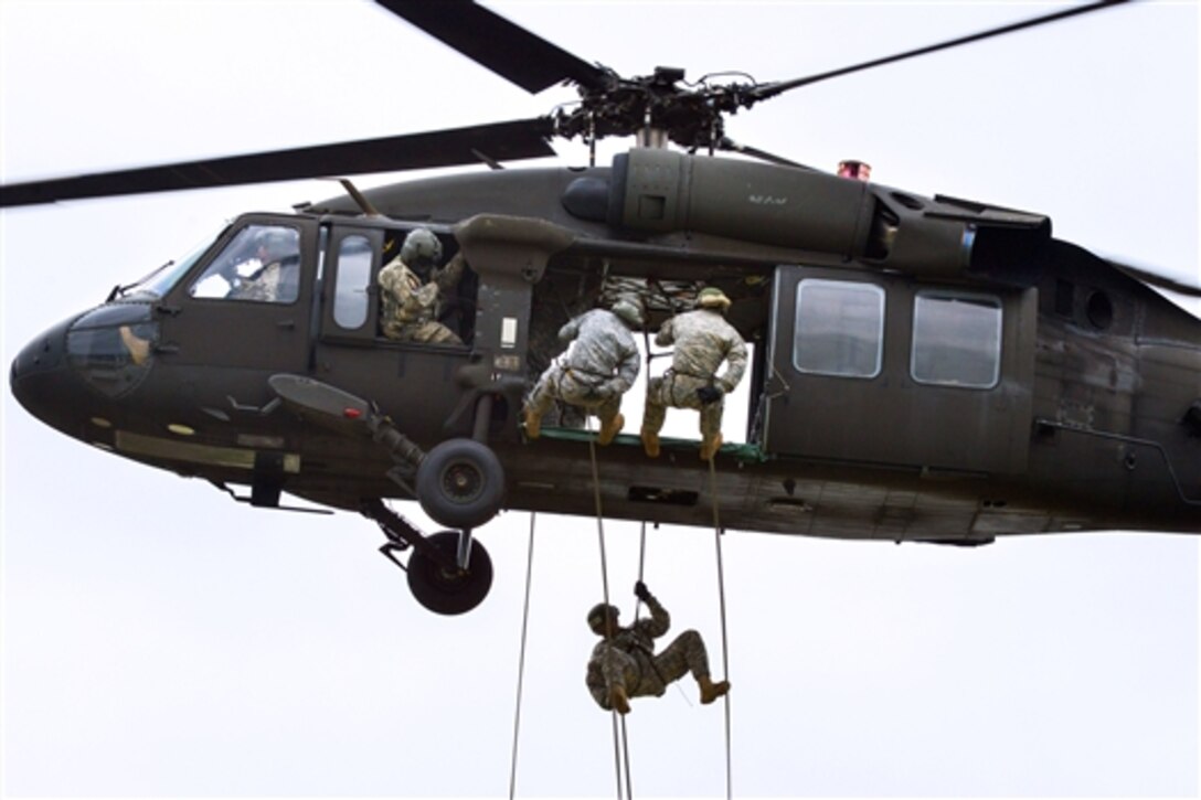 U.S. troops rappel from a UH-60 Black Hawk helicopter during an air assault course at the 7th Army Joint Multinational Training Command's Grafenwoehr Training Area in Bavaria, Germany, June 9, 2015.