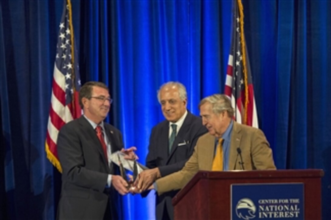 Defense Secretary Ash Carter accepts the Center for the National Interest’s 2015 Distinguished Service Award from Zalmay Khalilzad, a member of the center’s board of directors, and Graham Allison, a member of its advisory council, in Washington, D.C., June 9, 2015. 
