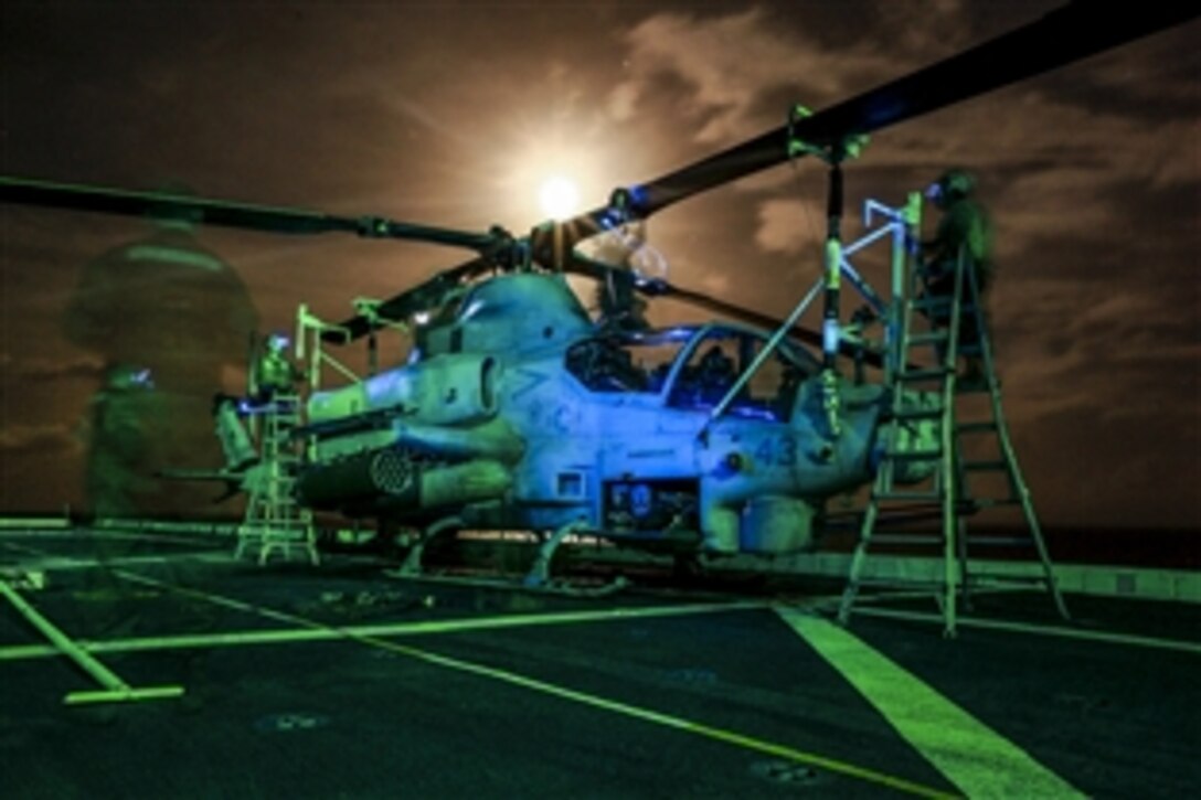U.S. Marines perform maintenance on an AH-1Z Viper helicopter aboard the USS Anchorage in the Philippine Sea, June 2, 2015. The Marines are assigned to Marine Medium Tiltrotor Squadron 161.