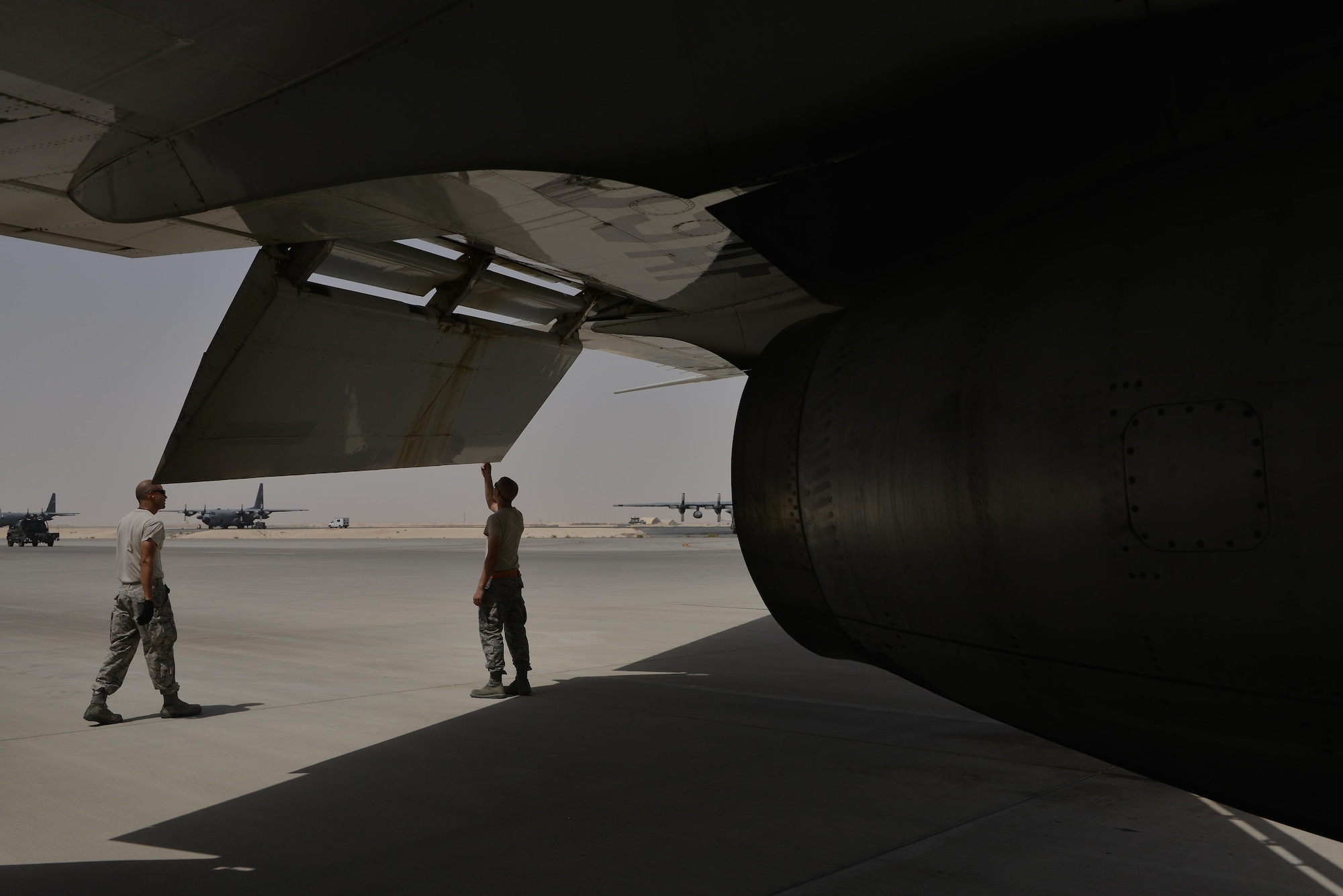 Airmen from the 7th Expeditionary Air Mobility Unit perform maintenance checks the exterior for damages and minor repairs of a Boeing E-8C Joint Surveillance Target Attack Radar Systems June 2, 2015 Al Udeid Air Base, Qatar. The E-8C JSTARS and its active duty, guard and reserve service members conduct missions overseas to support operations on the war on terror. During this time JSTARS completed 100K combat hours by continually flying 24/7 for 11.4 years. (U.S. Air Force photo/Staff Sgt. Alexandre Montes)