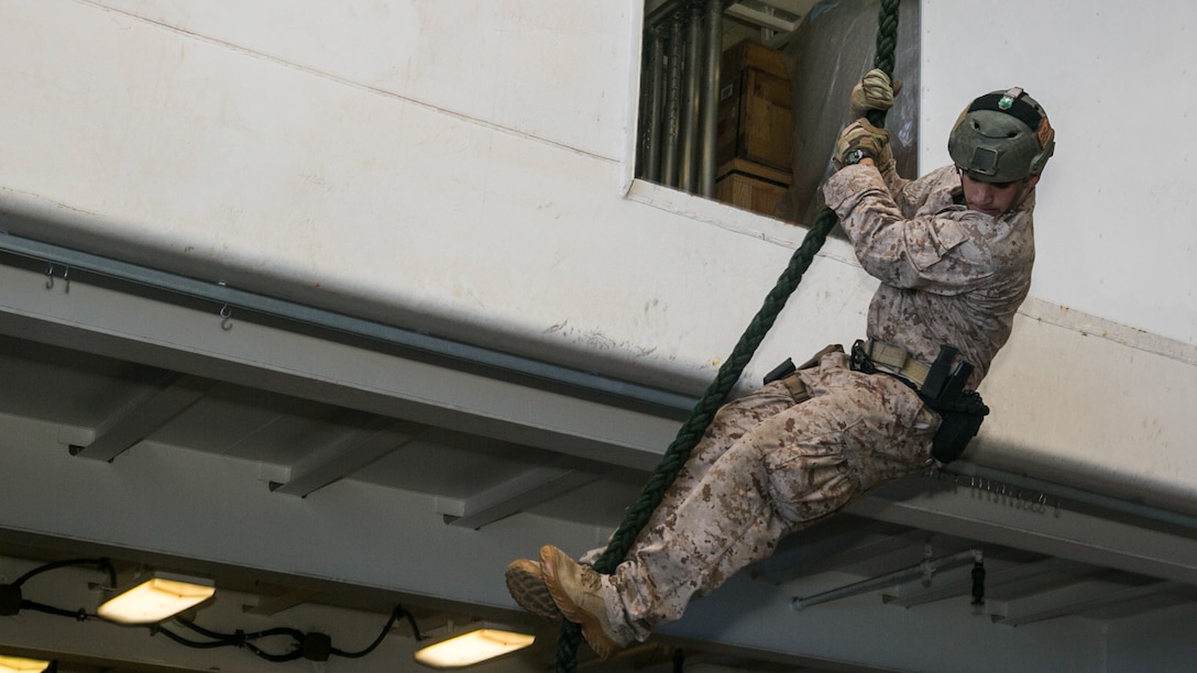 U.S. Marine Sgt. Joshua Mickles fast-ropes aboard the USS Essex (LHD 2) in the South China Sea, June 11, 2015. Mickles is with the 15th Marine Expeditionary Unit’s Maritime Raid Force. These Marines practice fast-roping so they are able to rapidly insert onto an objective via helicopter. 
