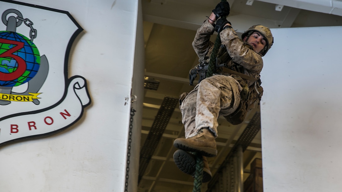 U.S. Marine Cpl. Nathan Kraus fast-ropes aboard the USS Essex (LHD 2) in the South China Sea, June 11, 2015. Kraus is a member of the 15th Marine Expeditionary Unit’s Maritime Raid Force. The MRF uses fast roping during visit, board, search, and seizure missions and precision ground raids when inserting from a helicopter. 