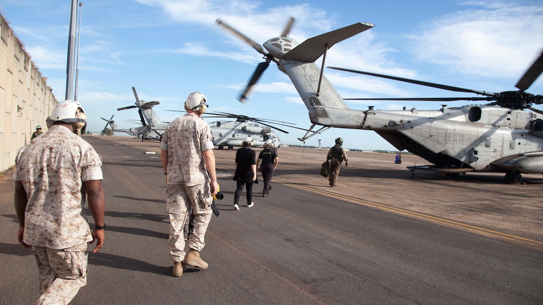 U.S. Marines, Australian media and the Lord Mayor of Darwin, Katrina Fong Lim, prepare to board a CH-53E Super Stallion helicopter with Marine Heavy Helicopter Squadron 463, Marine Rotational Force – Darwin, June 10 before a familiarization flight at  Royal Australian Air Force Base Darwin, Darwin, Northern Territory, Australia. The familiarization flight took off from RAAF Darwin, flew over the Port of Darwin and landed back at RAAF Darwin. MRF-D is an excellent opportunity to improve our knowledge of one another’s customs and traditions which ultimately strengthens U.S.-Australian military interoperability.  